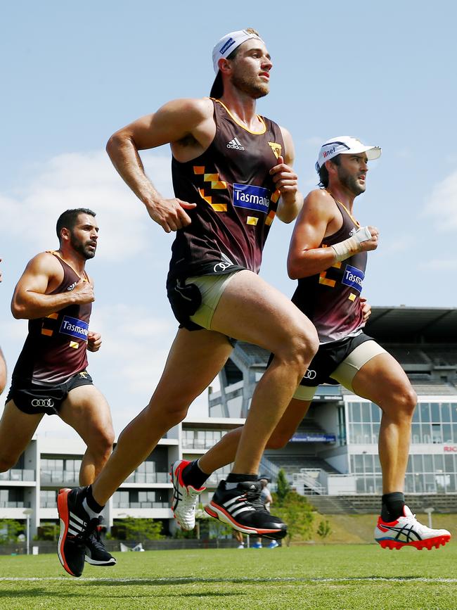 Lewis completes a running session with then-Hawthorn teammates Paul Puopolo and Ryan Schoenmakers during pre-season. No players was allowed to take their shirt off during sessions. Picture: Colleen Petch