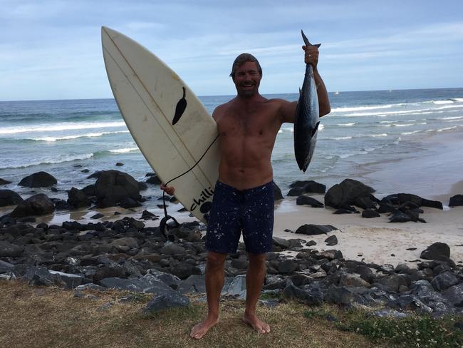 Nicholas Smith caught a Tuna in the ocean while surfing and had to fight off dolphins to keep it, he then went home and ate it.