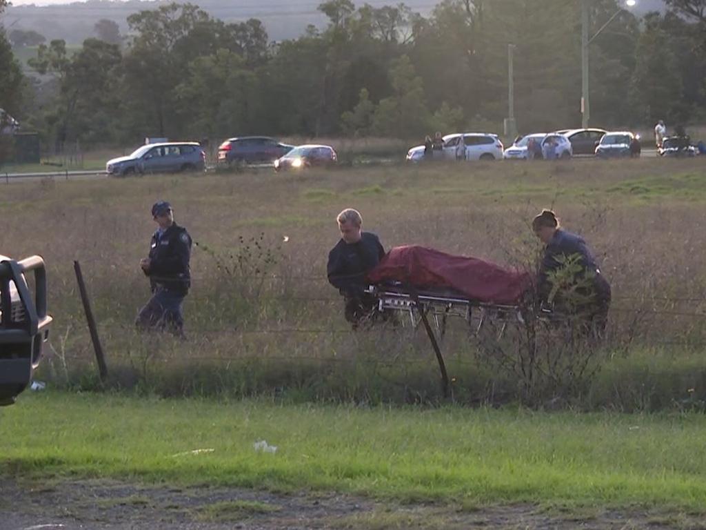 NSW Police forensic specialists remove the remains believed to be that of missing man Jayden Harwood from a paddock at Minto on Saturday. Picture: TNV