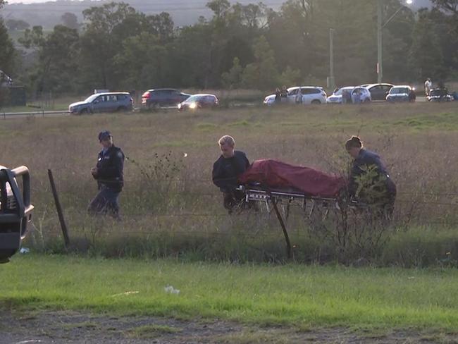 NSW Police forensic specialists remove the remains believed to be that of missing man Jayden Harwood from a paddock at Minto on Saturday. Picture: TNV