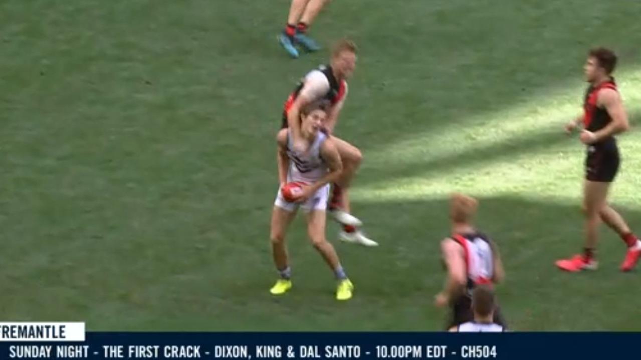 Essendon's Michael Hurley collects Fremantle's Sam Sturt late and high.