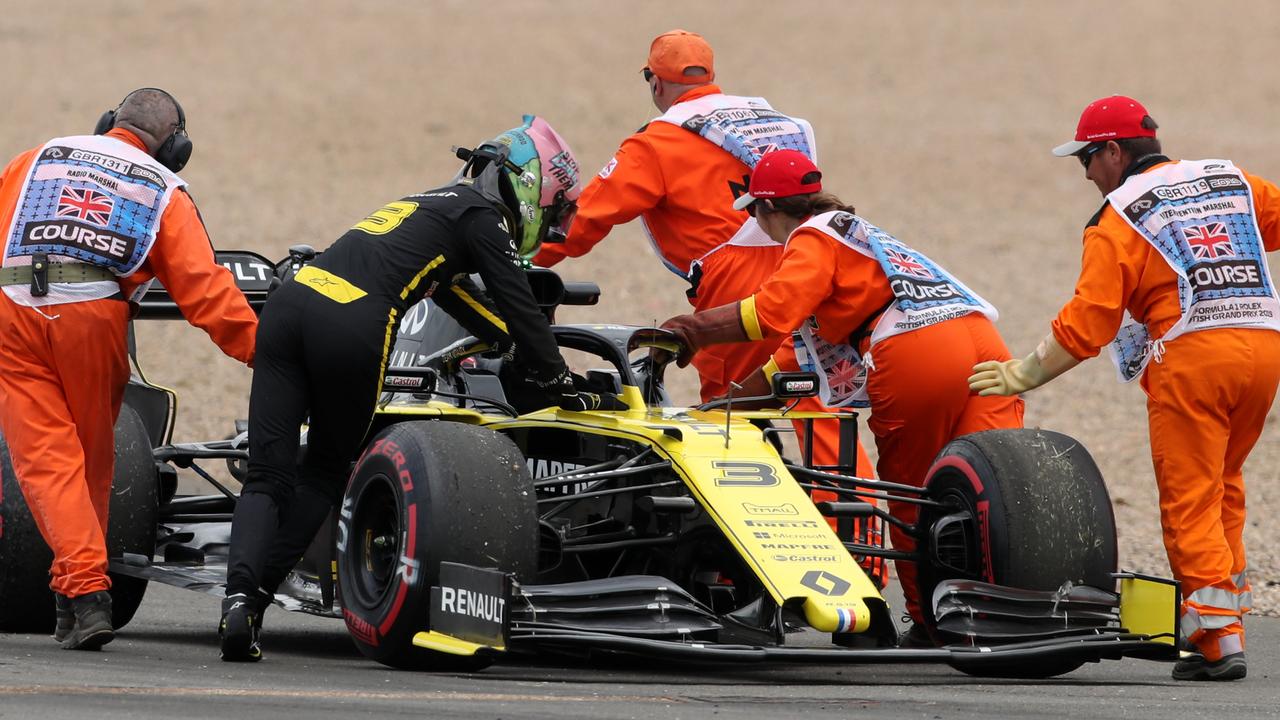 Renault driver Daniel Ricciardo helps the marshalls to push his car. (Photo by Bradley Collyer/PA Images via Getty Images)