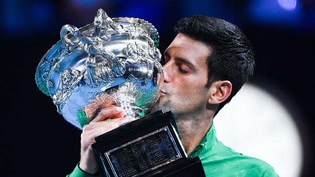 Serbia's Novak Djokovic kisses the Norman Brooks Challenge Cup trophy following his victory against Austria's Dominic Thiem in their men's singles final match.