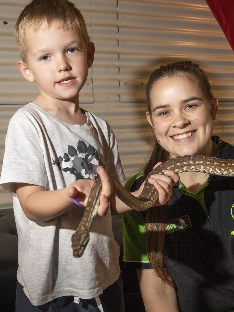 Mason Willing 5yo and wildlife presenter Maddy Mercer with Nutella the Bredli python. Cobb+Co Museum Easter school holiday program Wildlife Rangers with Wildcall Wildlife Shows. Monday, April 4, 2022. Picture: Nev Madsen.