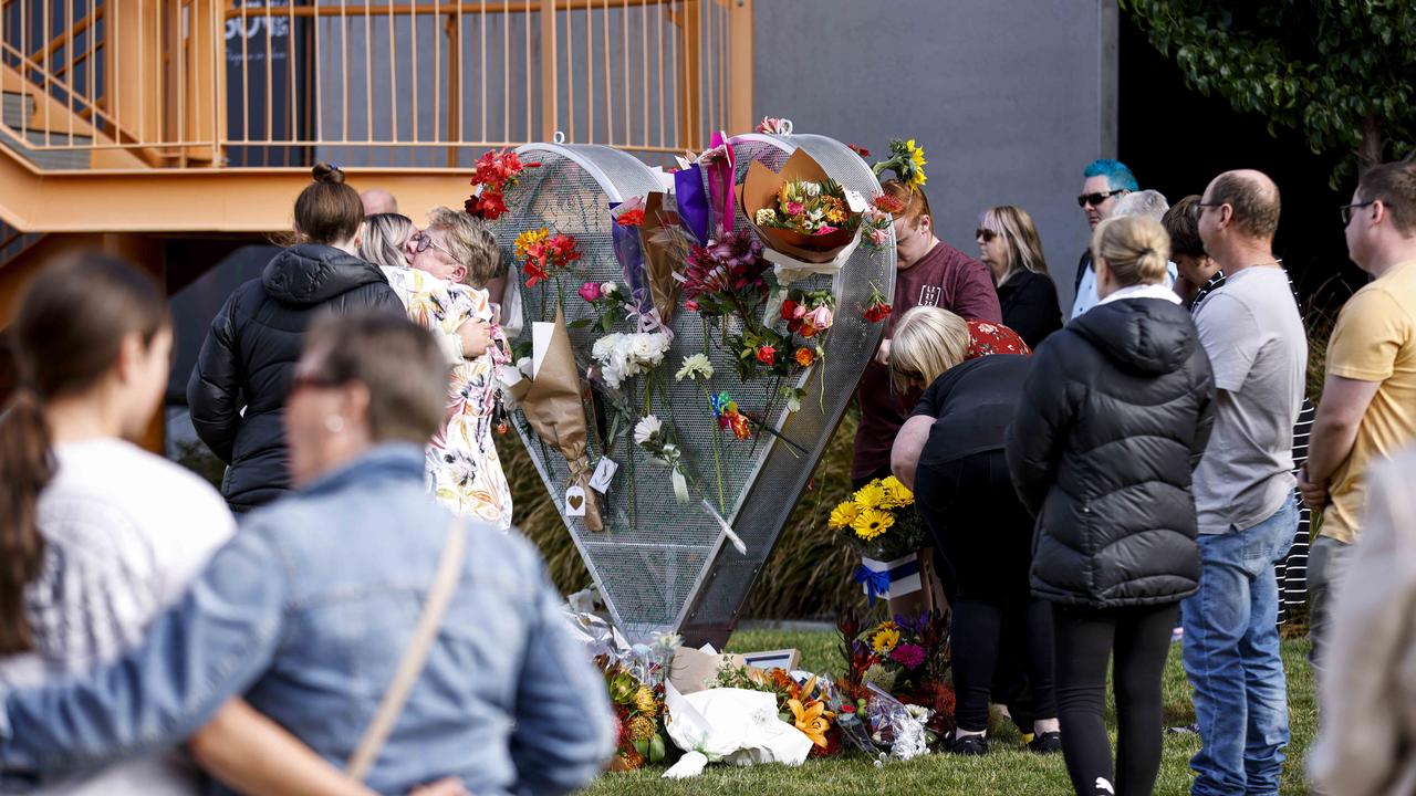 Mourners lay Flowers at the heart shaped sculpture in Market Square Devonport. Thursday December 15th 2022. Picture: Grant Viney