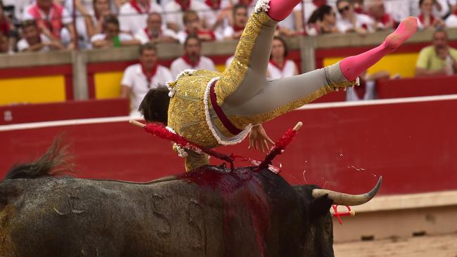 Bloodbath: Blood and sweat flow freely from the bull as the torment continues at the hands of Spanish bullfighter Gonzalo Caballero on day two of the festival. Picture: AP/Alvaro Barrientos)