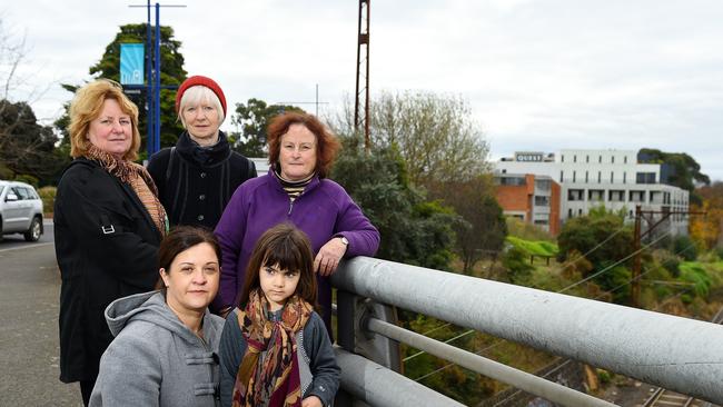 Residents fear a proposed apartment building will dominate Ivanhoe’s skyline and set a precedent for other tall buildings. Robyn Roberts, Pippa Griffith, Julia Stafford, Helen Mavrokefalos (front) and Kristiana, 5. Picture: Josie Hayden