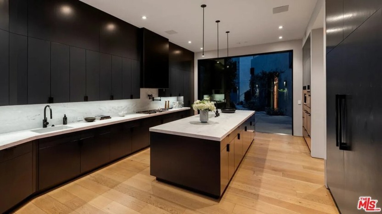 The chef’s kitchen has dark-wood accents and a large island. (Picture: Realtor.com)