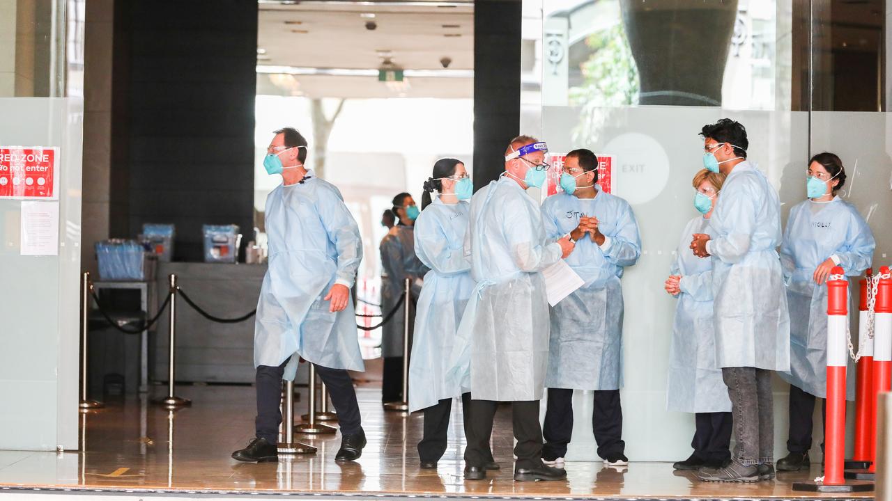 Hotel Quarantine workers wearing full PPE at the Grand Hyatt Melbourne Hotel on January 20. Picture: Asanka Ratnayake