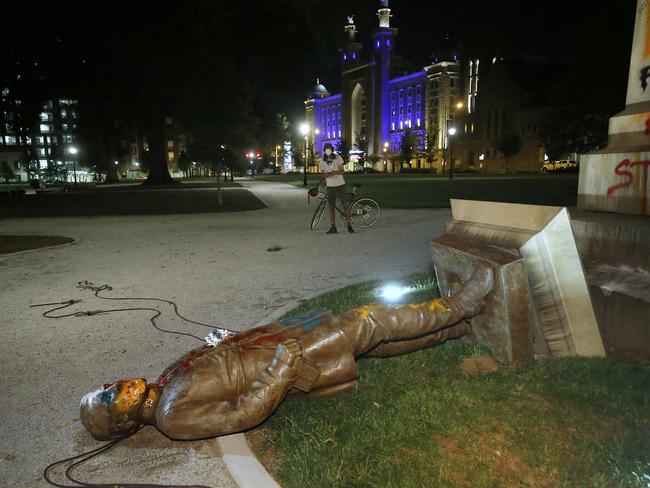 The statue of Confederate Gen. Williams Carter Wickham lies on the ground after protesters pulled it down. Picture: AP