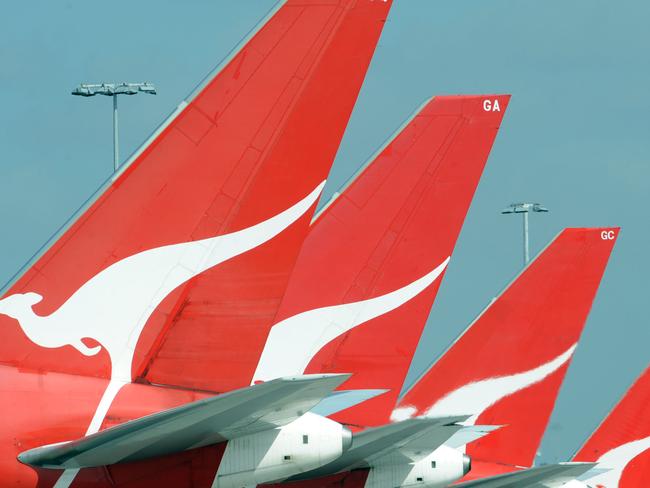 **FILE** A Dec. 3, 2008 file photo of the tails of Qantas jets at Sydney International Airport. Qantas Airways Ltd's first-half profit slumped 66 per cent, Wednesday, Feb. 4, 2009, as fuel and labour costs buffeted Australia's biggest airline. (AAP Image/Dean Lewins,File) NO ARCHIVING