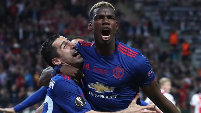 Henrikh Mkhitaryan (L) with Paul Pogba of Manchester United.