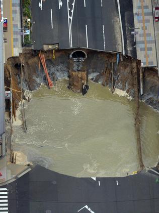 A massive sinkhole is filling with water in the middle of the business district in Fukuoka, southern Japan. Picture: AP