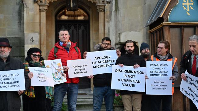 Pro-LGBT+ activists take part in a demonstration outside of Church House. (Photo by JUSTIN TALLIS / AFP)