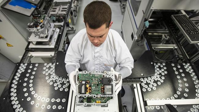 An employee examines an electric-vehicle component at Continental’s powertrain factory in Nuremburg, Germany. Picture: Alex Kraus/ Bloomberg.