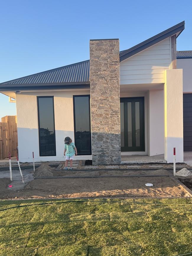 Ashlee Smallfield's son in the front yard of their new home.Picture: Supplied