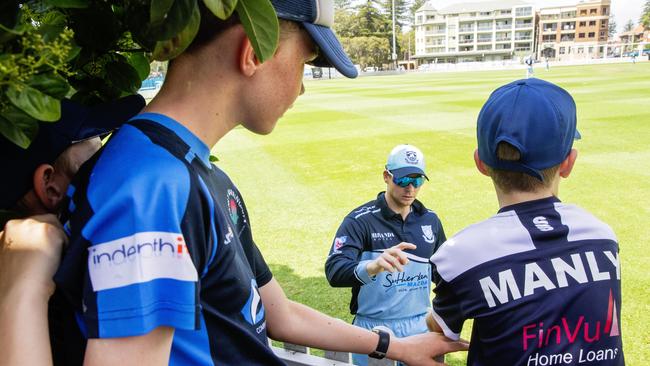 Steve Smith signs autographs for kids during a T20 game between Manly and Sutherland. Picture: Jenny Evans