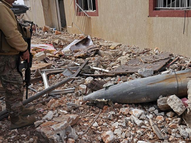 A Lebanese soldier checks the remains of a rocket in a residential area. Picture: AFP