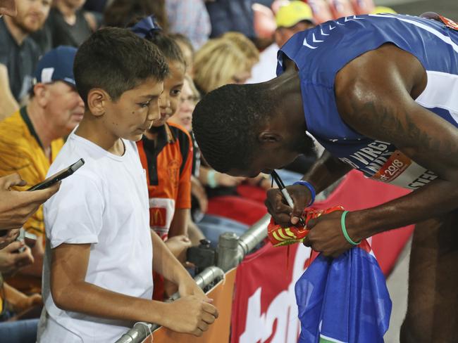 Kyron Mcmaster of the British Virgin Islands signs on a pair of his shoes