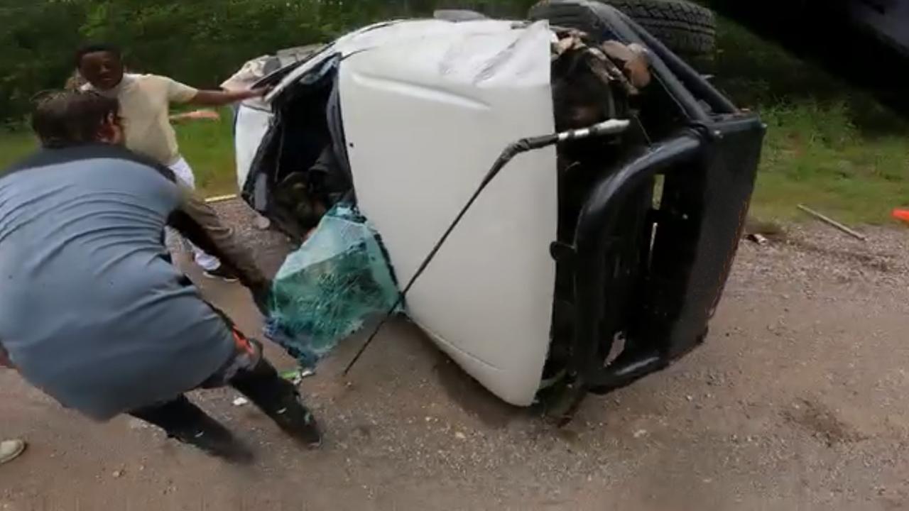 People helping out at the scene of the ute rollover at Beerburrum, Sunshine Coast on Sunday.