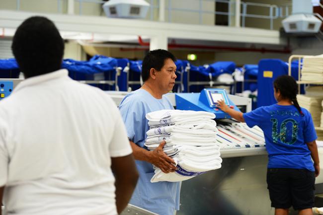 Royal Darwin Hospital staff members prepare the clean towels and laundry to be transported to the hospital. Picture: Ivan Rachman