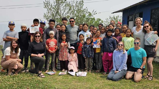 Som Tamang with children and volunteers on his return to Batase to mark the ninth anniversary of the earthquake. Picture: Kirsty Nancarrow