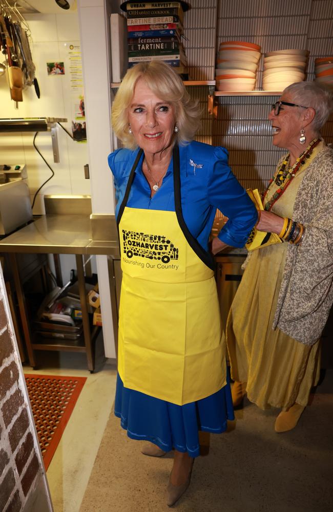 Queen Camilla assists with meal preparation during a visit to Refettorio OzHarvest SydneY. Picture: Getty