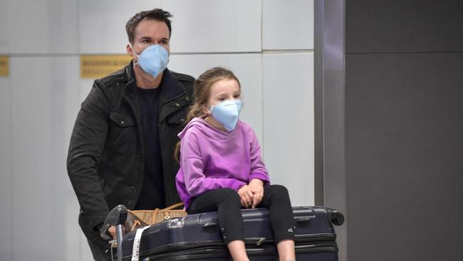 Passengers, wearing masks as a precautionary measure to avoid contracting coronavirus make their way through Guarulhos International Airport in Brazil. Picture: Nelson Almeida/AFP