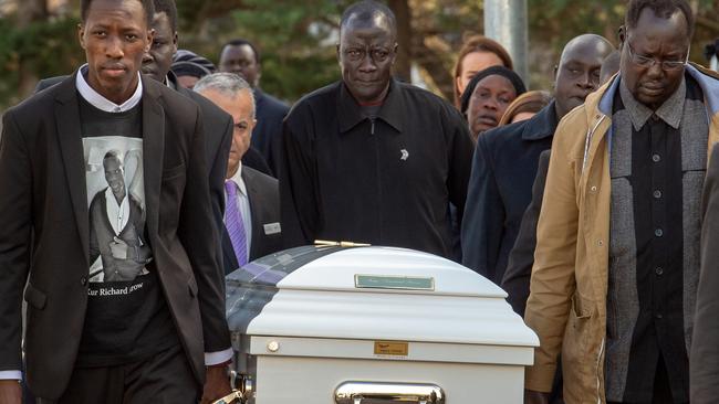 Pallbearers carry Richard Arow’s coffin. Picture: Jay Town