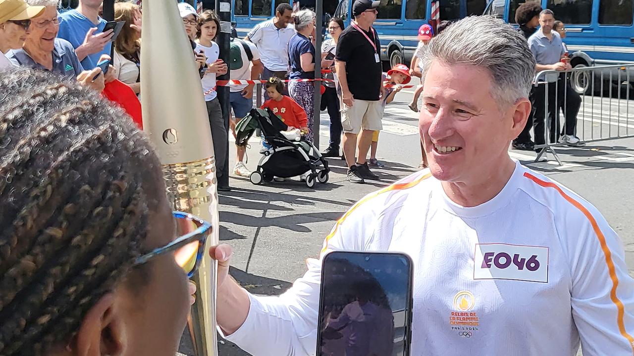 Nine CEO Mike Sneesby carries the Paris Olympics torch in the Olympic torch relay. Picture: Jacquelin Magnay