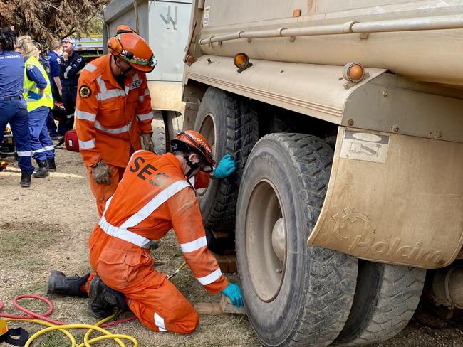 Coffs Harbour SES use airbags to lift a truck trailer after it pinned a man in Glenreagh.