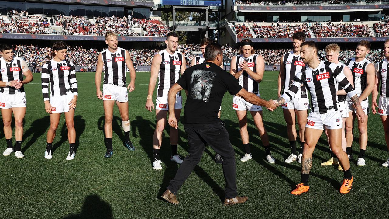 Part of the pre-game involved Winmar shaking hands with the Collingwood players in a show of unity. Pic: Michael Klein