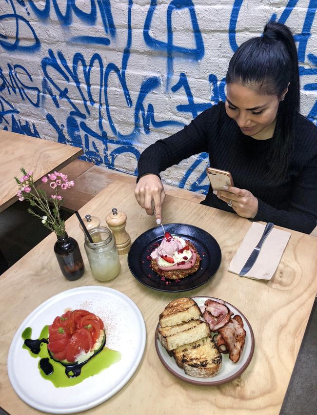 Food influencer Katherine Gennusa from LickYourPhone puts her food in a frame for SnapSydney 2018 at Devon Cafe, Surry Hills.