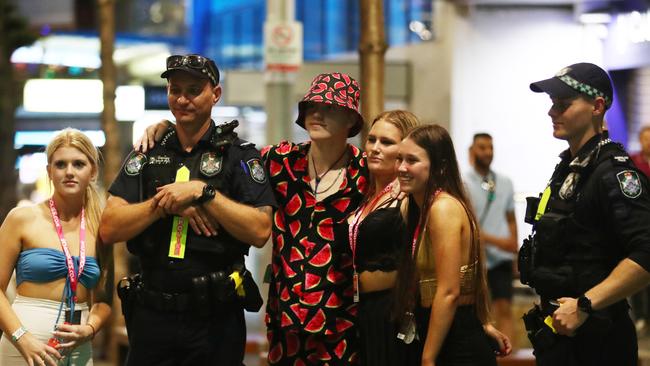 School leavers interact with obliging Queensland Police officers at Surfers Paradise. Picture: Jason O'Brien