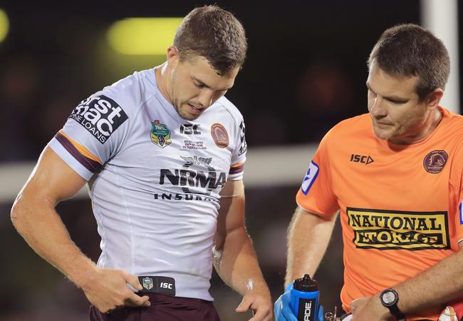 Corey Oates of the Broncos goes off the field with a hip injury.