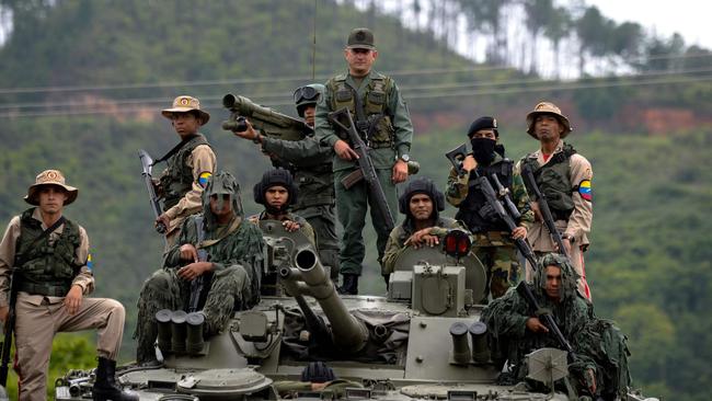 Venezuelan troops stand on top of a Russian tank. Picture: Federico Parra