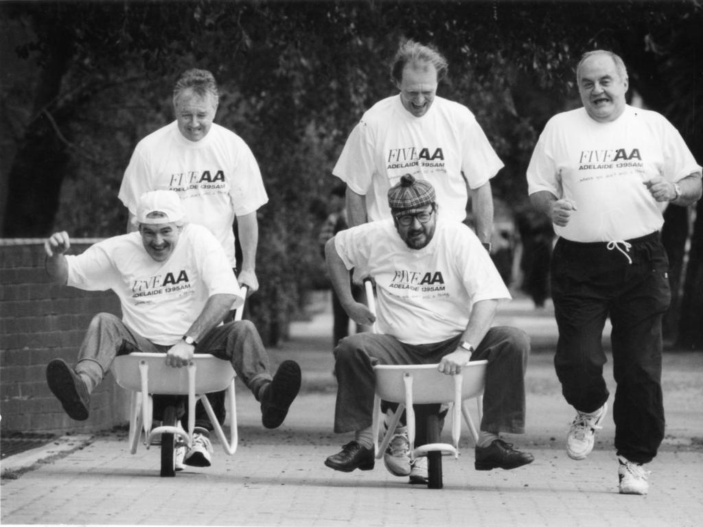 Radio 5AA personalities promote The Advertiser City-Bay Fun Run, July, 1995. K.G. Cunningham and Graham Cornes give Tony ‘Pilko’ Pilkington and Barry ‘Bazz’ Ion a helping hand with training, while Bob Francis runs alongside.