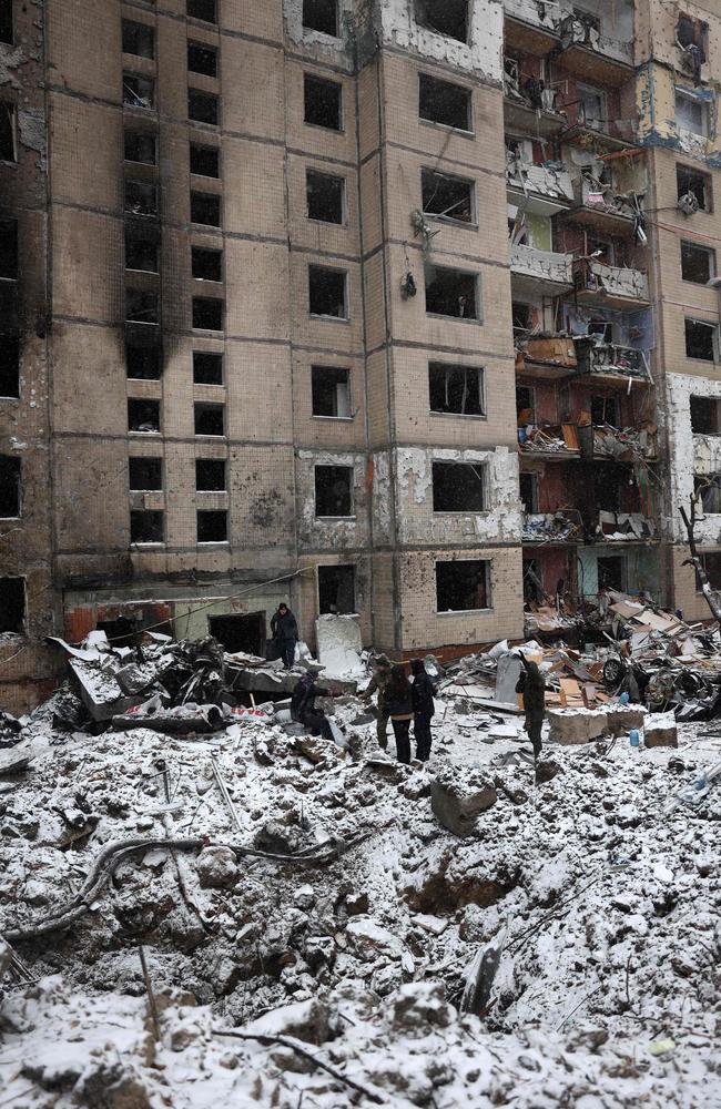 Police officers and local residents inspect damage outside a destroyed high-rise building following a Russian missile attack in central Kyiv, on January 3, 2024. Picture: Anatolii Stepanov / AFP