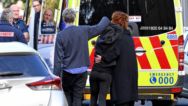 A suspected drug overdose victim being led to an ambulance as nearby Victorian Premier Daniel Andrews announced a two-year trial of a heroin injecting room in the inner Melbourne suburb of Richmond. Picture: Joe Castro/AAP