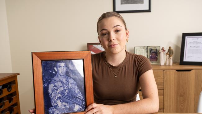 Mia Douglas with a photo of her father Kevin Douglas. Photo: Joseph Byford Photography