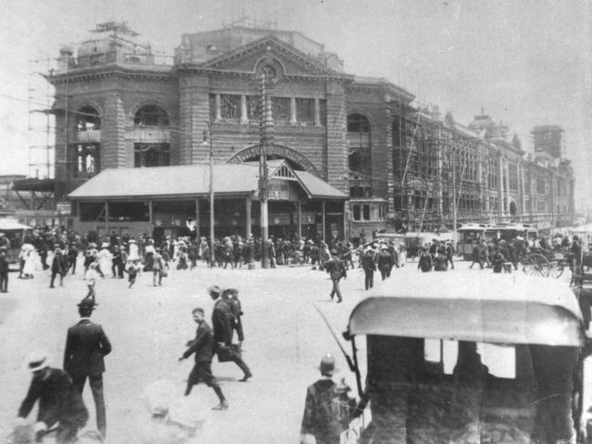 Flinders Street Station under construction around 1908, before the dome was built over the main entrance. The old station entrance is still visible in the foreground. Picture: HWT Library.