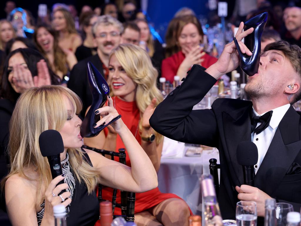 Kylie Minogue reluctantly performs a “shoey” with Roman Kemp. Picture: Getty Images