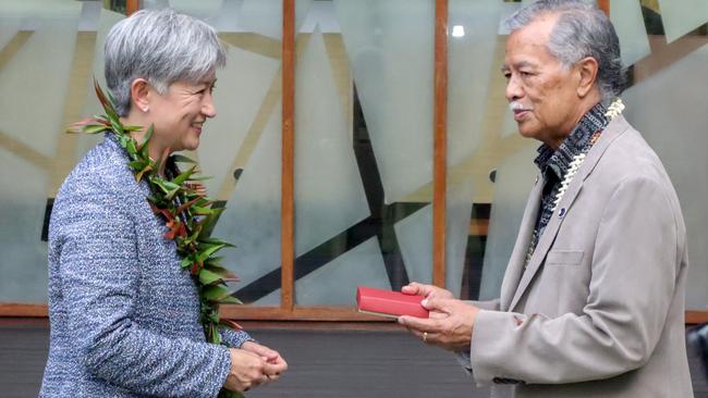 Penny Wong exchanges gifts with Henry Puna, Pacific Island Forum secretary-general, in Suva, Fiji. Picture: Getty Images