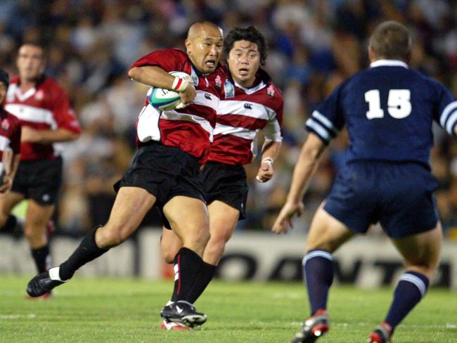 RWC 2003 Scotland v Japan @ Dairy Farmers Stadium.12/10/2003 - Japan's Takeomi Ito makes a run Scotland's Ben Hinshelwood - Pic Bruce Long