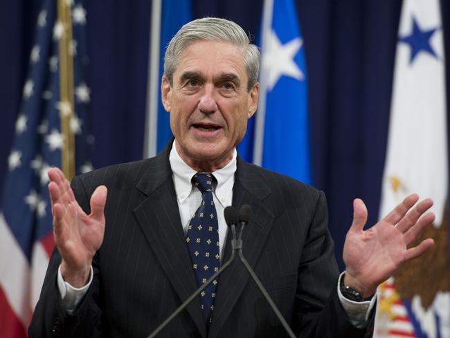 (FILES) In this file photo taken on August 1, 2013, Federal Bureau of Investigation (FBI) Director Robert Mueller speaks during a farewell ceremony in Mueller's honor at the Department of Justice. - The FBI is investigating an alleged scheme to pay women to smear Russia collusion probe head Robert Mueller with sexual harassment allegations, Mueller's office said on October 30, 2018. The scheme was uncovered after one woman who said she worked for Mueller decades ago told several journalists she had been offered $20,000 to accuse him of sexual misconduct. (Photo by Saul LOEB / AFP)