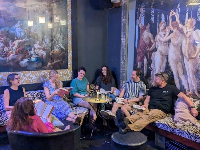 Lost in the pages: Silent Book Club members and venue coowner Briant Clark share a quiet moment of reading and reflection at The Last Supper Pizzarella. Picture: Taylor Mason.