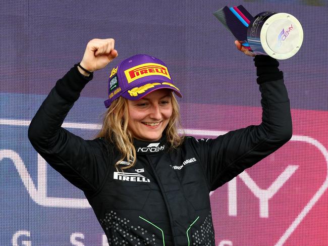 JEDDAH, SAUDI ARABIA - MARCH 09: Race winner Doriane Pin of France and PREMA Racing (28) celebrates on the podium during Round 1 Jeddah race 2 of the F1 Academy at Jeddah Corniche Circuit on March 09, 2024 in Jeddah, Saudi Arabia. (Photo by Clive Rose/Getty Images)