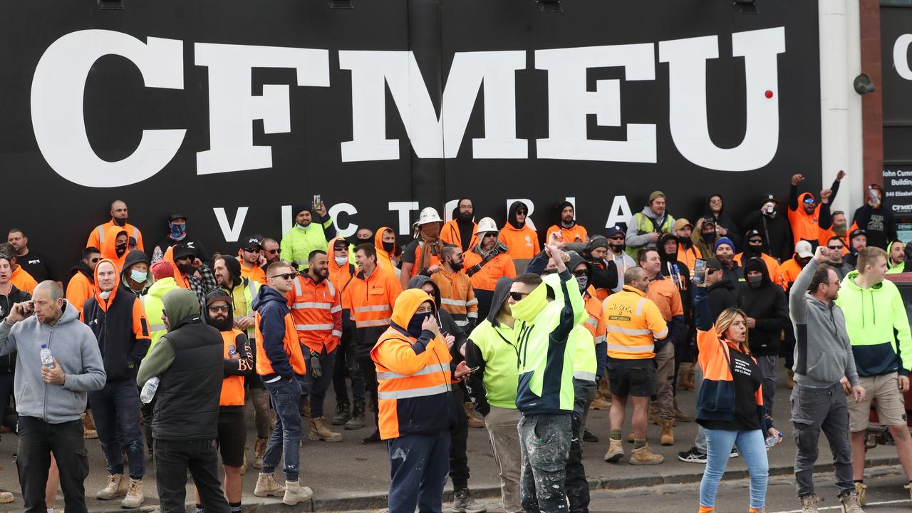 Construction workers gather in front of the CFMEU headquarters on Elizabeth Street. Picture: David Crosling