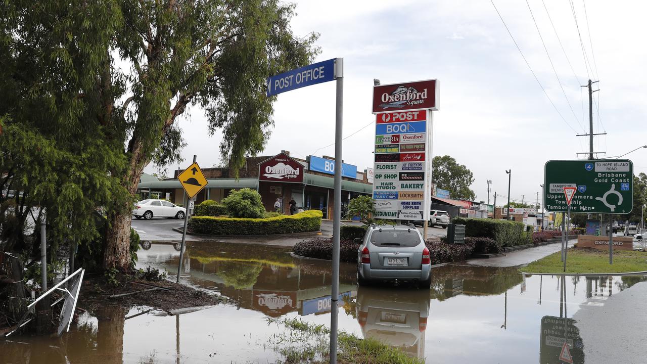 A vehicle caught in the flash flood in front of Oxenford Square, Gold Coast, Saturday, January 18, 2020. A severe thunderstorm swept the Coast during the early hours of the day dumping 128mm of rain in an hour. (AAP Image/Regi Varghese)