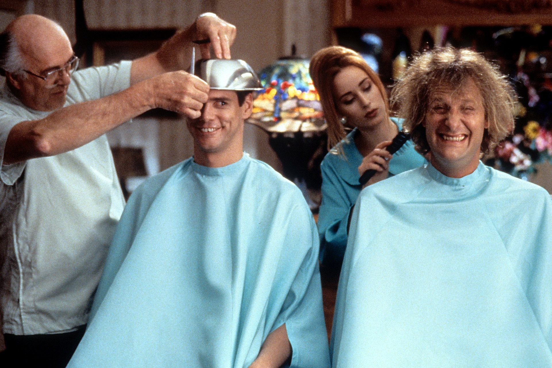 Jim Carrey and Jeff Daniels getting their hair cut in a scene from the film...